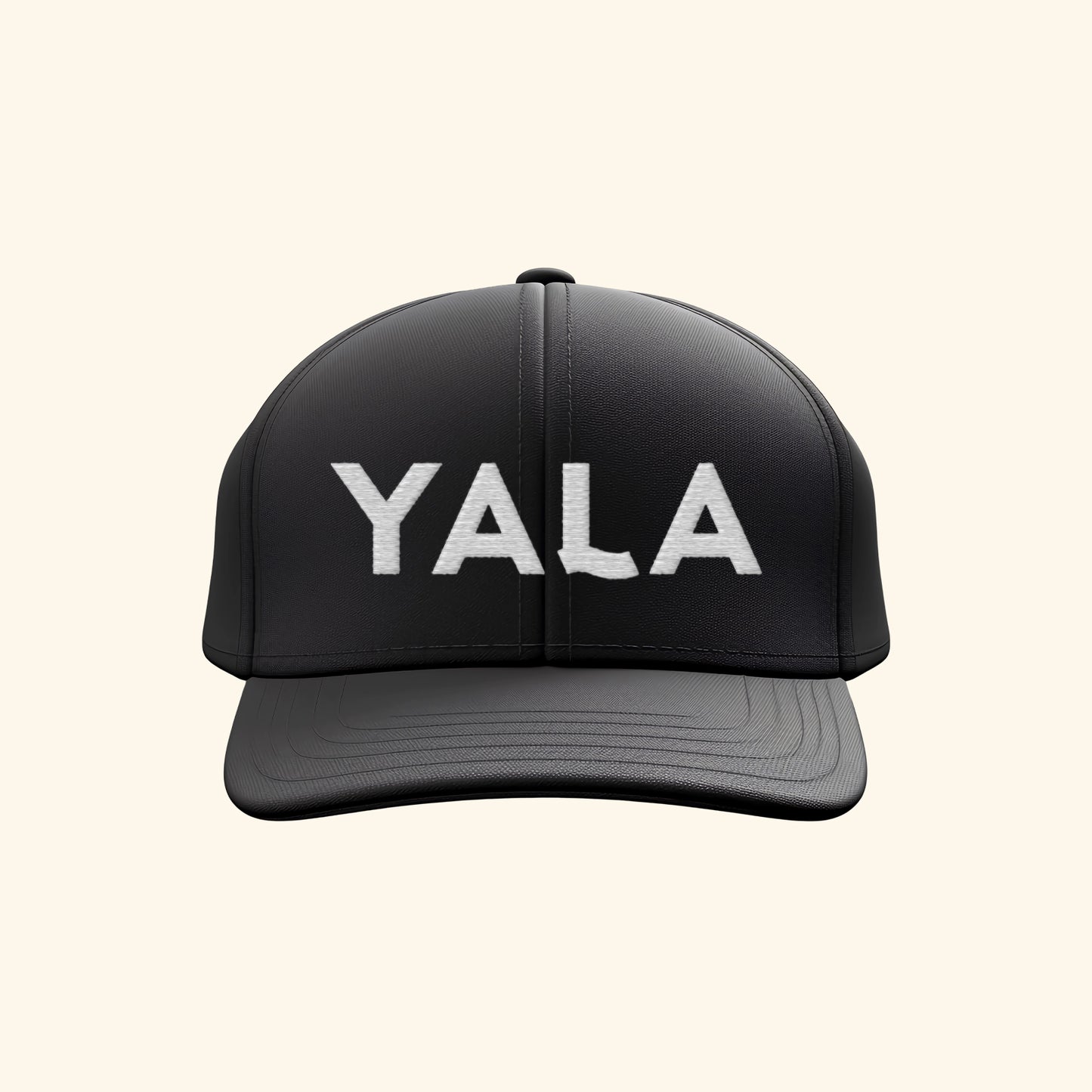 YALA Kombucha black baseball cap with white embroidered logo on cream background